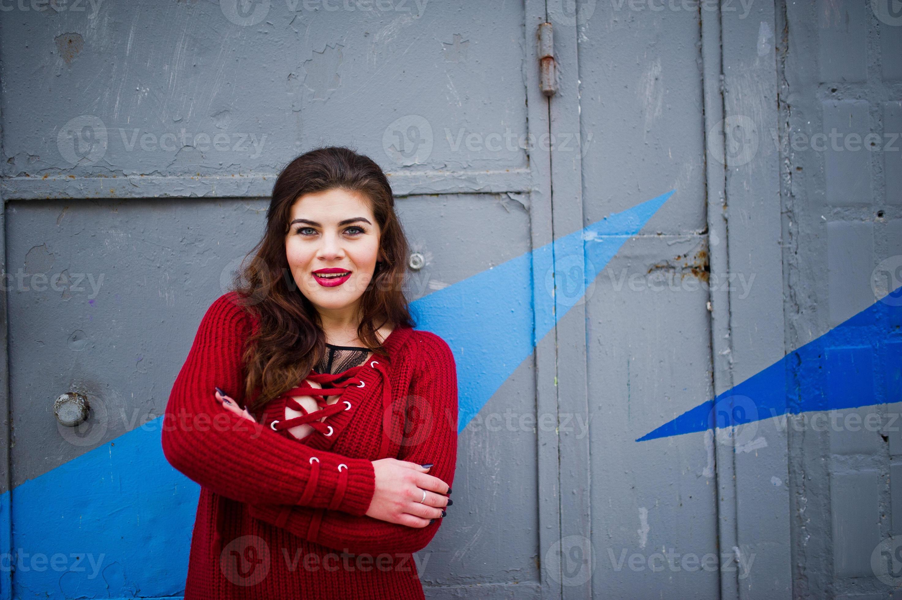 Brunette Plus Size Model At Red Against Colored Wall Stock Photo At Vecteezy