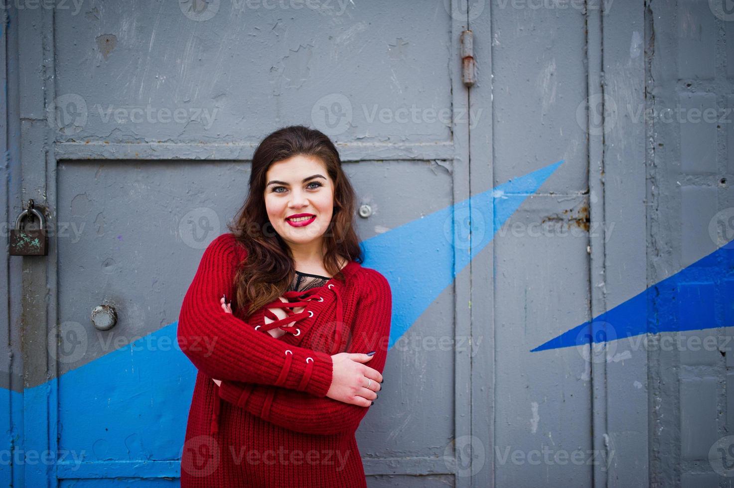 Brunette Plus Size Model At Red Against Colored Wall Stock Photo At Vecteezy