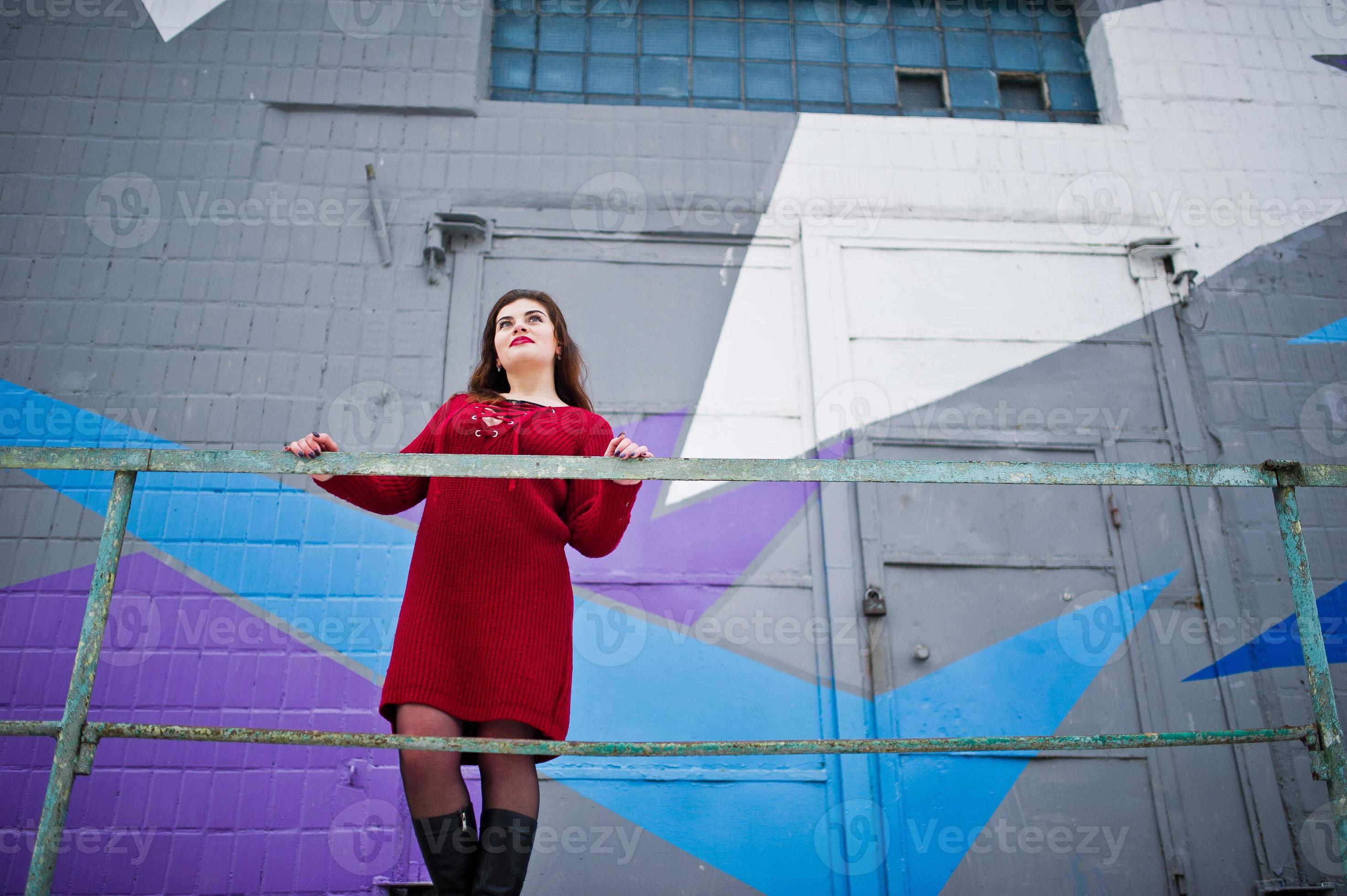 Brunette Plus Size Model At Red Against Colored Wall Stock Photo At Vecteezy
