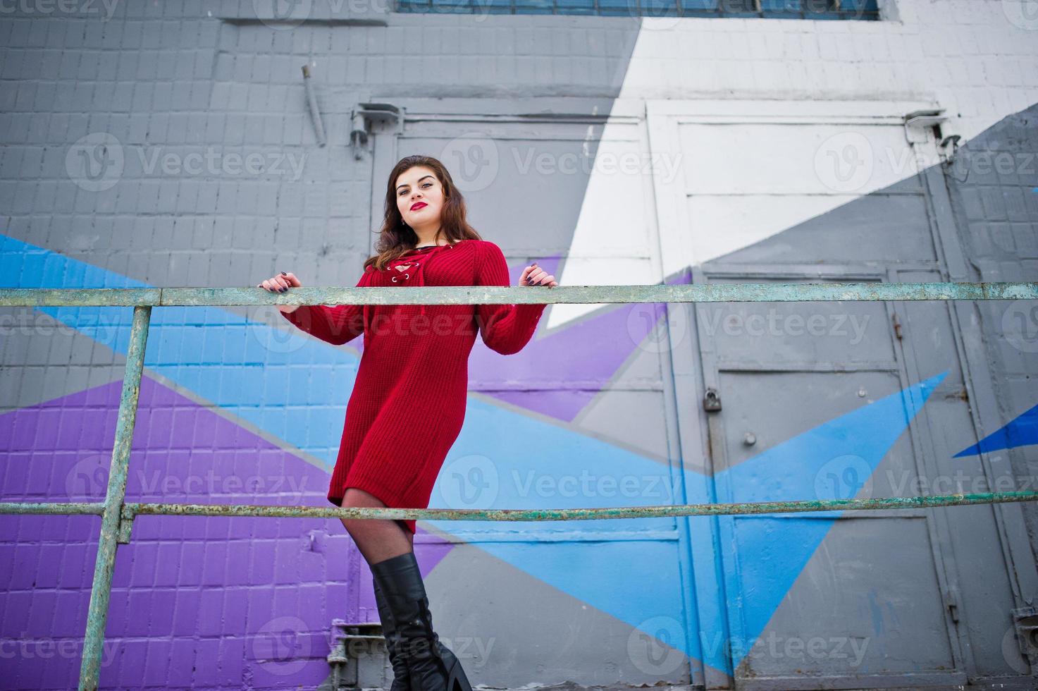 Brunette Plus Size Model At Red Against Colored Wall Stock Photo At Vecteezy