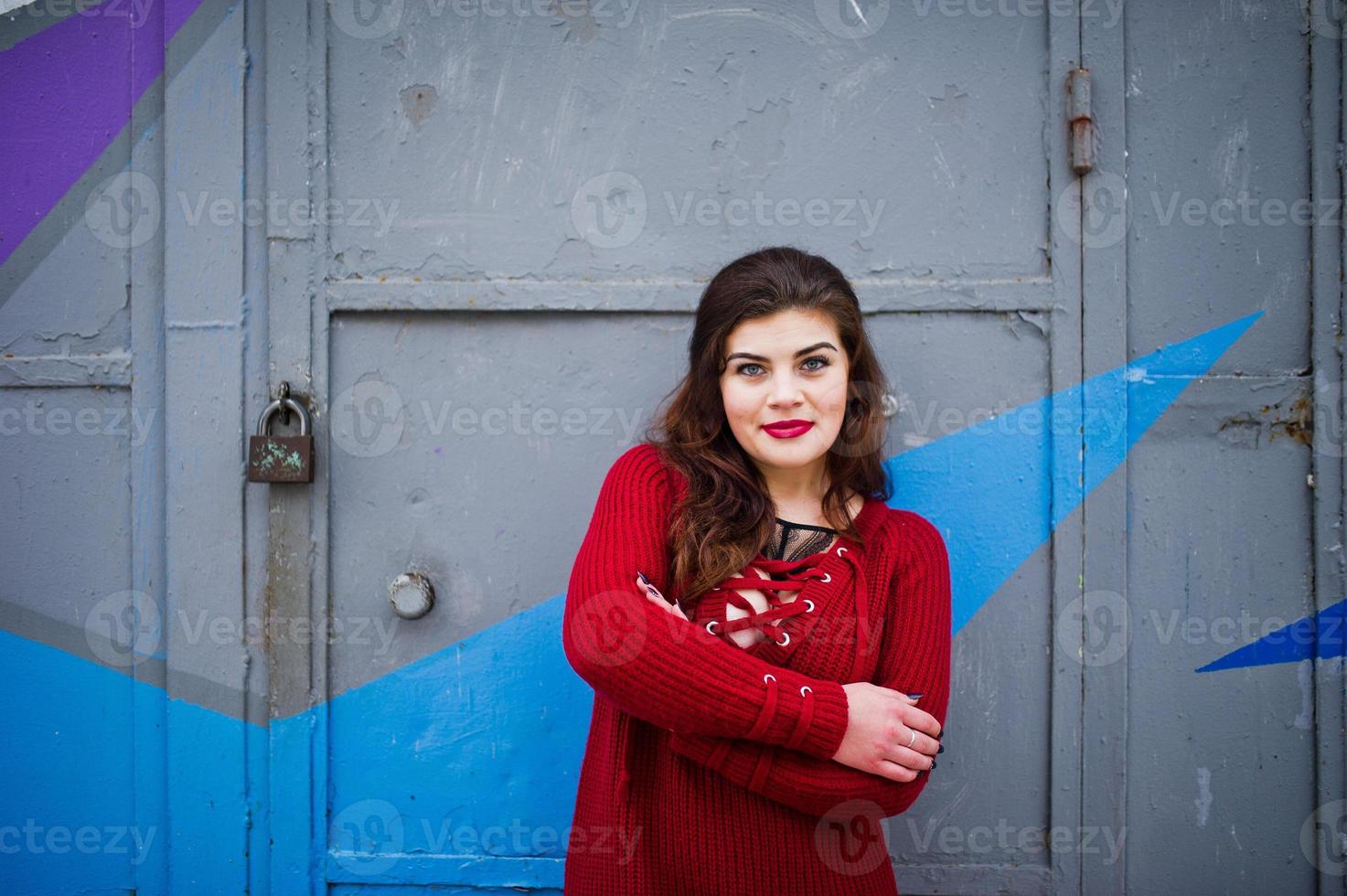 Brunette Plus Size Model At Red Against Colored Wall Stock Photo At Vecteezy