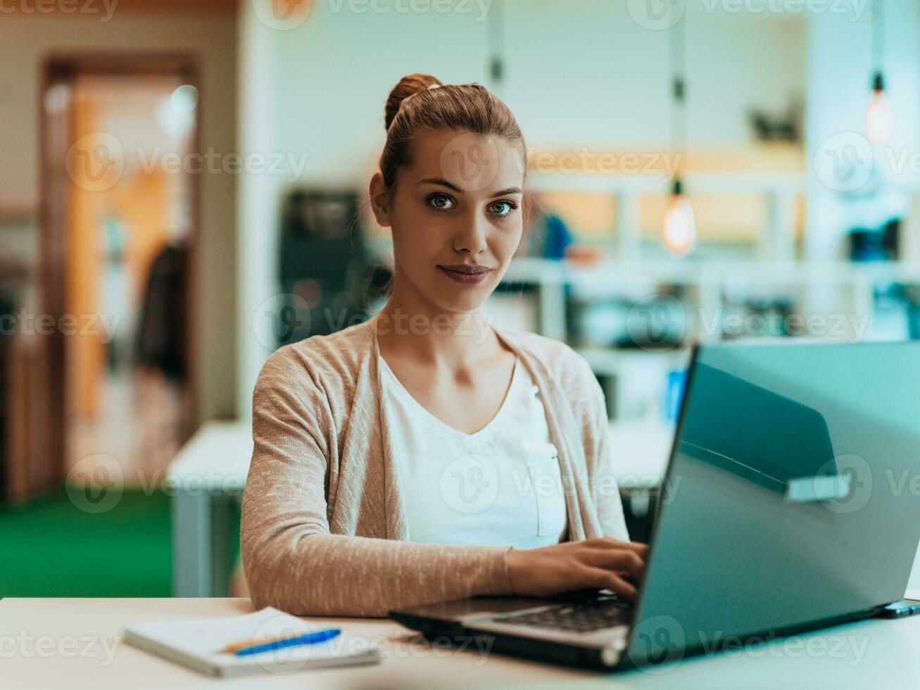 Blonde Manager Working Behind Her Desk In A Modern Office Stock Photo At Vecteezy