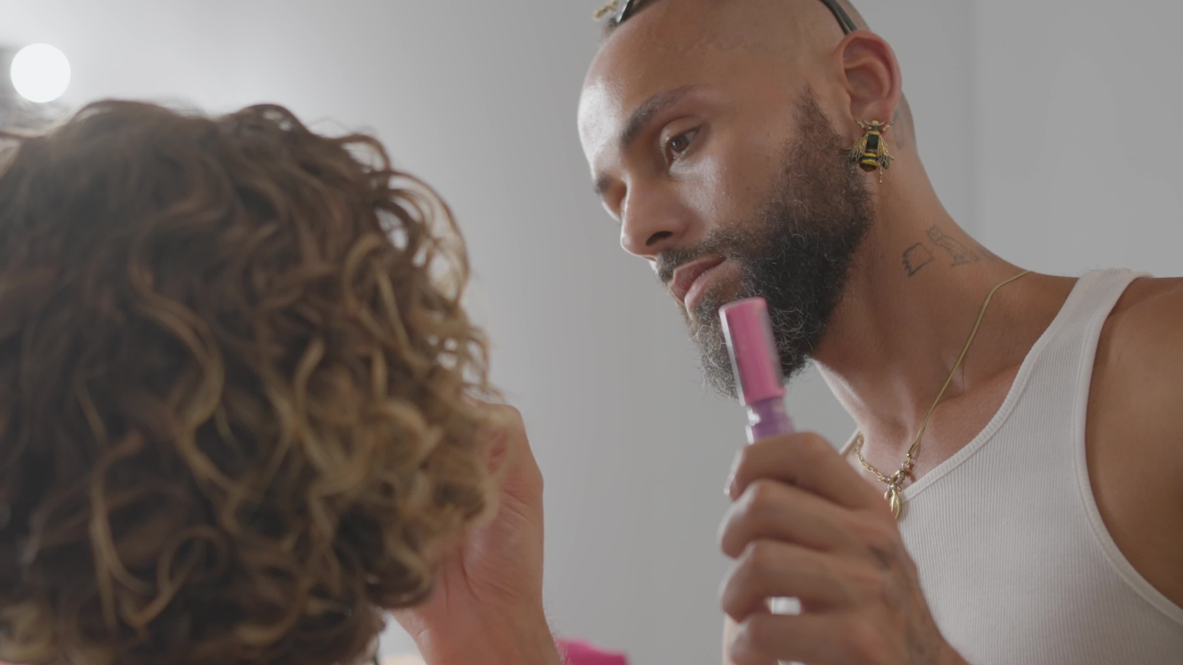 Makeup Artist Apply Make Up For Woman Who In Front Of Mirror Bearded Gay Professional Make Up