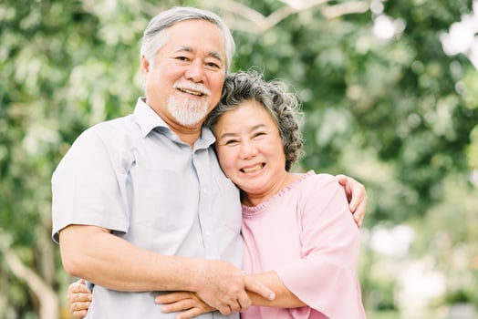 Senior couple embracing in outdoor park photo
