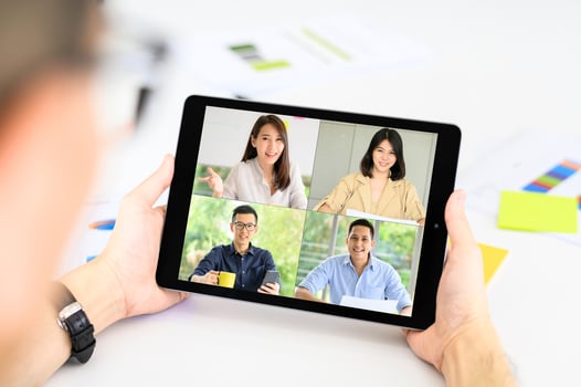Businessman meets with Asian colleagues in video conference photo