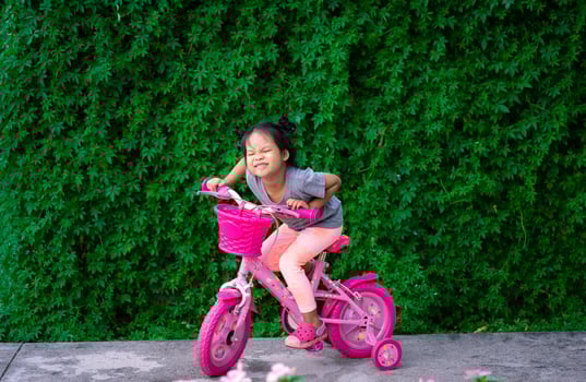 Young Asian girl riding a bicycle photo
