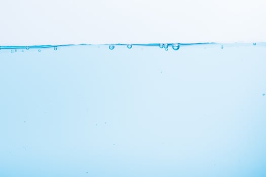 Surface of blue water on a white background photo