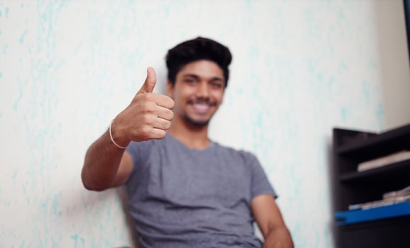 Young Asian boy showing thumbs up photo