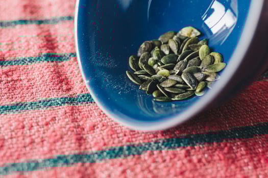 Green pumpkin seeds in bowl photo