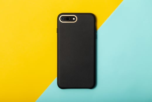 Black smartphone on yellow blue background photo