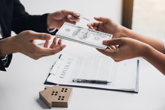 Real estate agent giving money to home buyer photo