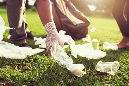 Volunteers picking up garbage at a park photo
