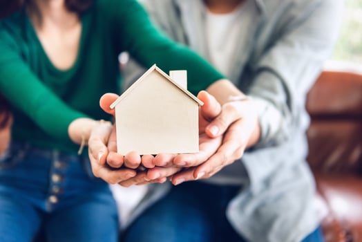 Couple holding model house photo