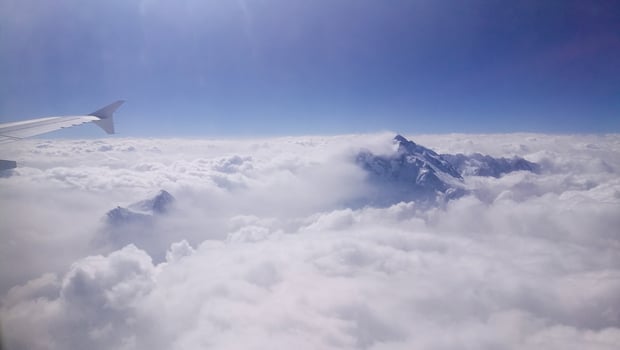 Mountain peak emerges from cloud photo