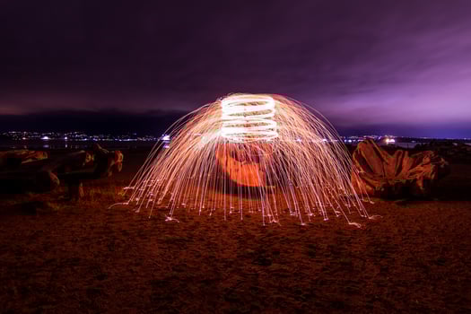 Long-exposure of steel wool on seashore photo