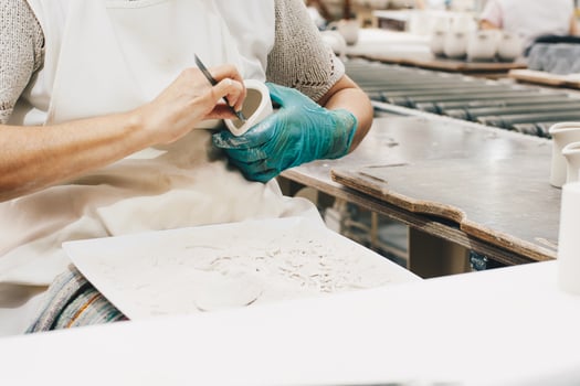 Person wearing a glove carving photo