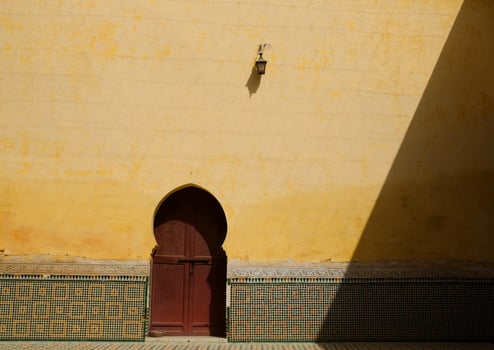 Vintage Moroccan door against yellow wall photo