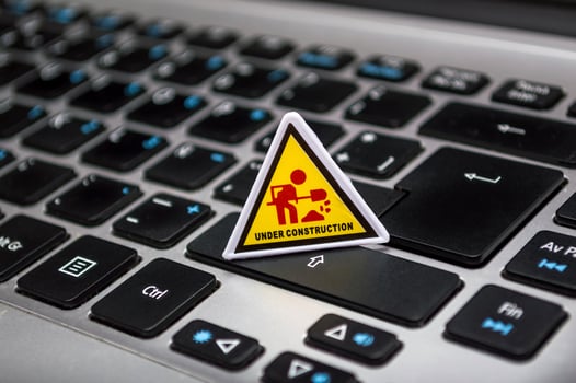 Under construction signage on laptop keyboard photo