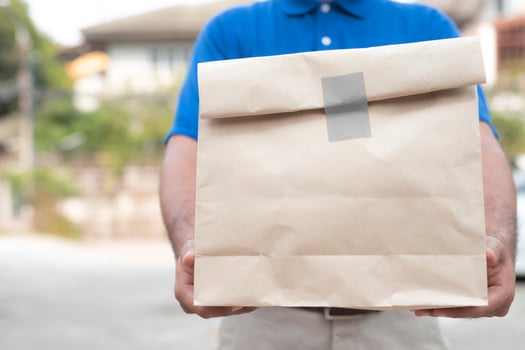 Man holding paper bag photo