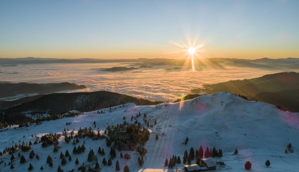 Sun rises above mountain landscape photo
