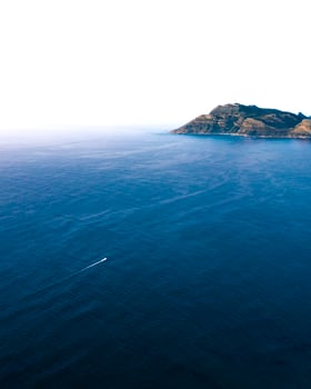 Sea near the mountain during daytime photo