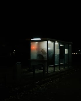 Silhouette of person at bus stop photo