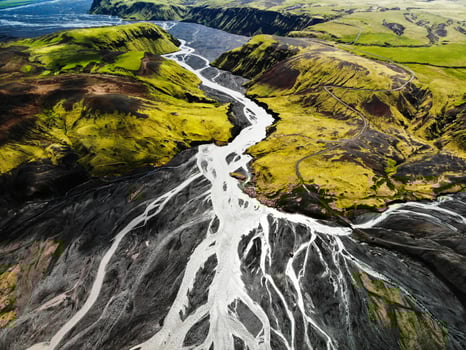 Aerial view of river flowing through mountains photo