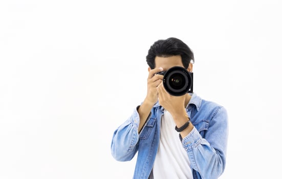 Male photographer in front of white background photo