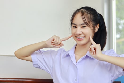 Young woman smiling with braces on photo