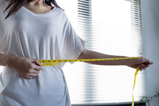 Woman with perfect waist with measuring tape photo