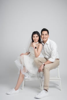 Bride and groom sitting on chair photo