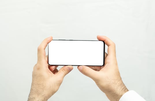 Holding a horizontal white screen smartphone photo