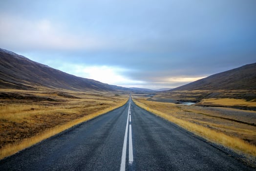 Road running through a hilly landscape photo