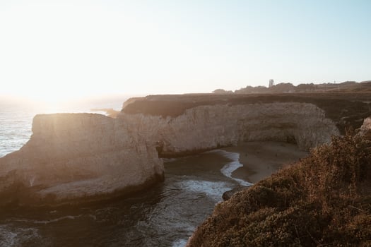 Golden hour on cliff by sea photo