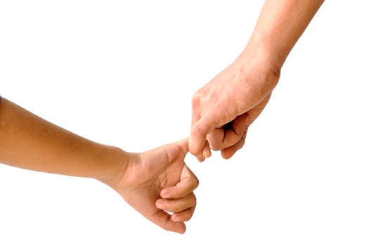 Adult holding child's hand isolated on background photo
