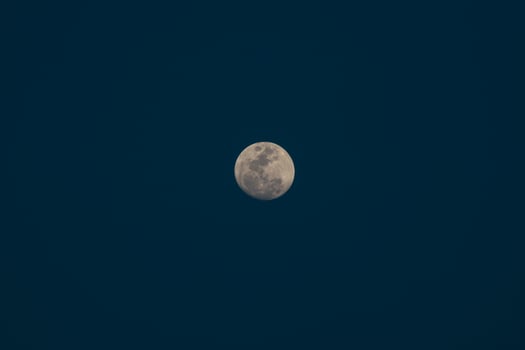 Crescent moon on dark sky photo