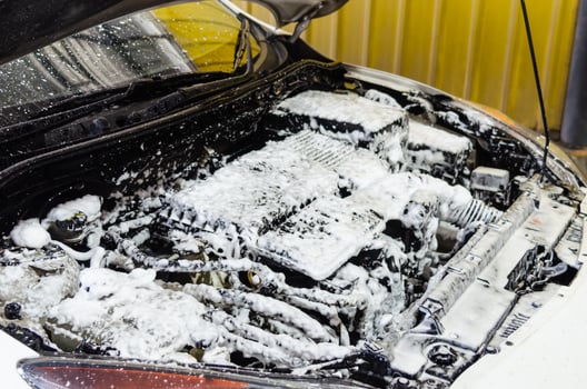 Car engine being cleaned photo