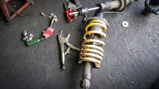Shock absorber for a car on mechanic floor photo