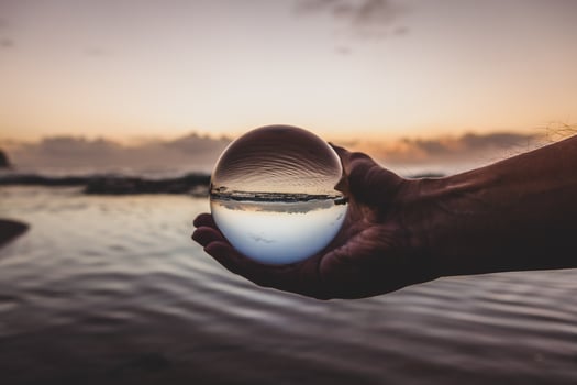 Person holding a glass ball photo