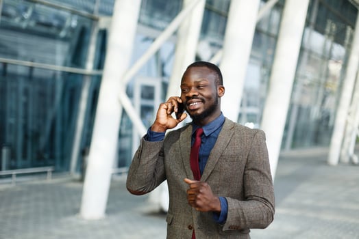 Stylish African American black businessman talks on his smartphone photo