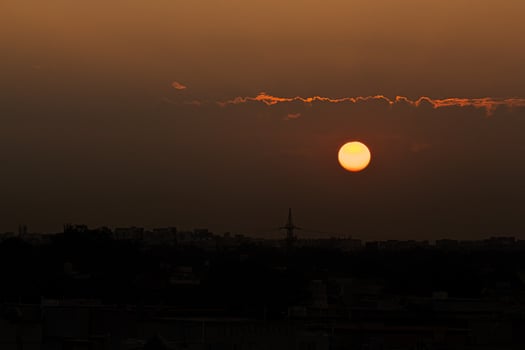 Setting sun in a dark sky photo