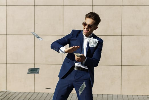 Young man in a suit with a lot of money photo