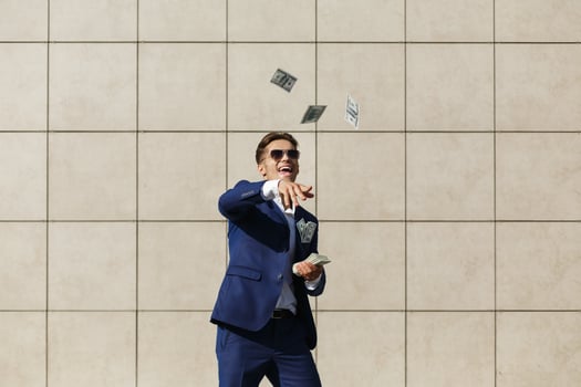 Young businessman throws around dollars and dances on the street photo