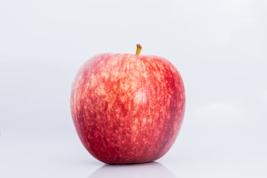 A red apple is shown on a white background photo