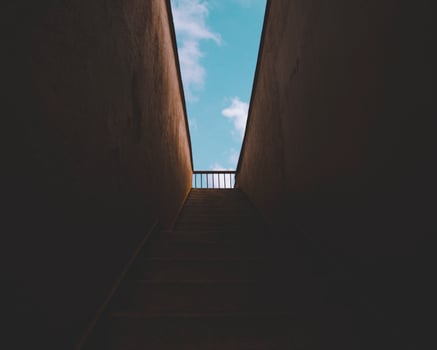Dark staircase leading outside photo