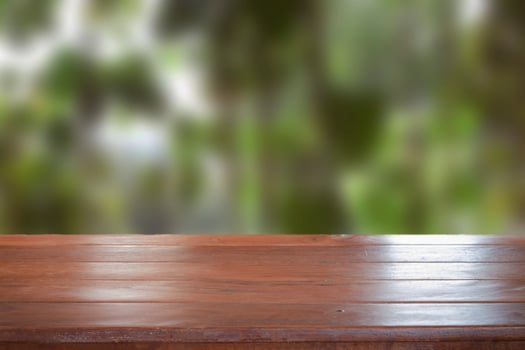 Old empty wooden table top with blurred background photo