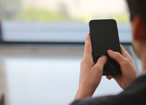 Soft focus of business person holding mobile phone photo