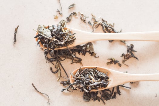 Top view of oolong tea in wooden spoons photo