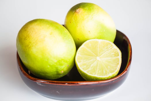 Fresh limes in a ceramic bowl photo