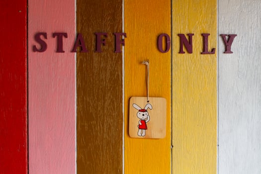 Staff only sign on a painted wall photo